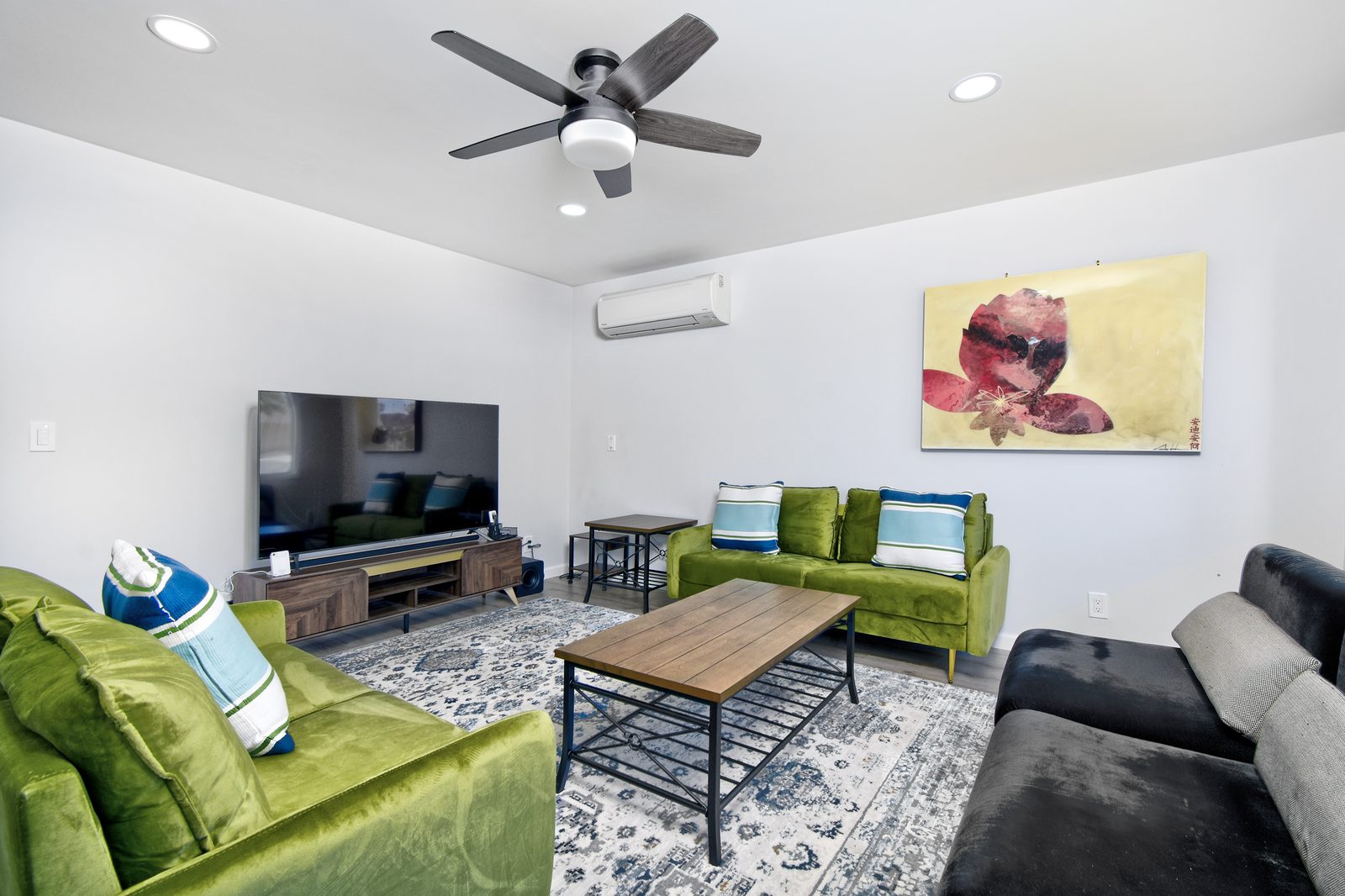 Great room in the 2-bedroom home with a green sofa